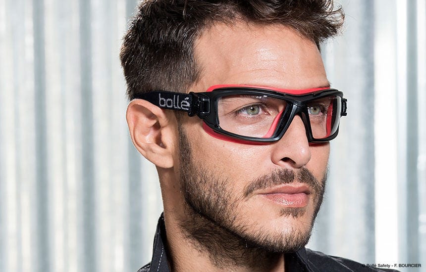Man Wearing Bolle ULTIM8 Safety Glasses/Goggle with Black/Red Temples, Foam Gasket and Clear Platinum Anti-Fog Lens