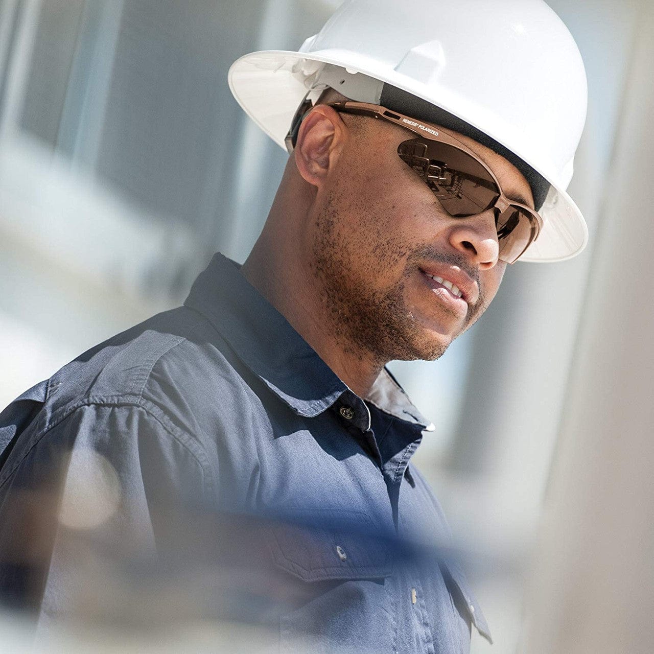 Worker wearing KleenGuard 28637 Nemesis Polarized Safety Glasses Brown Frame with Brown Lenses